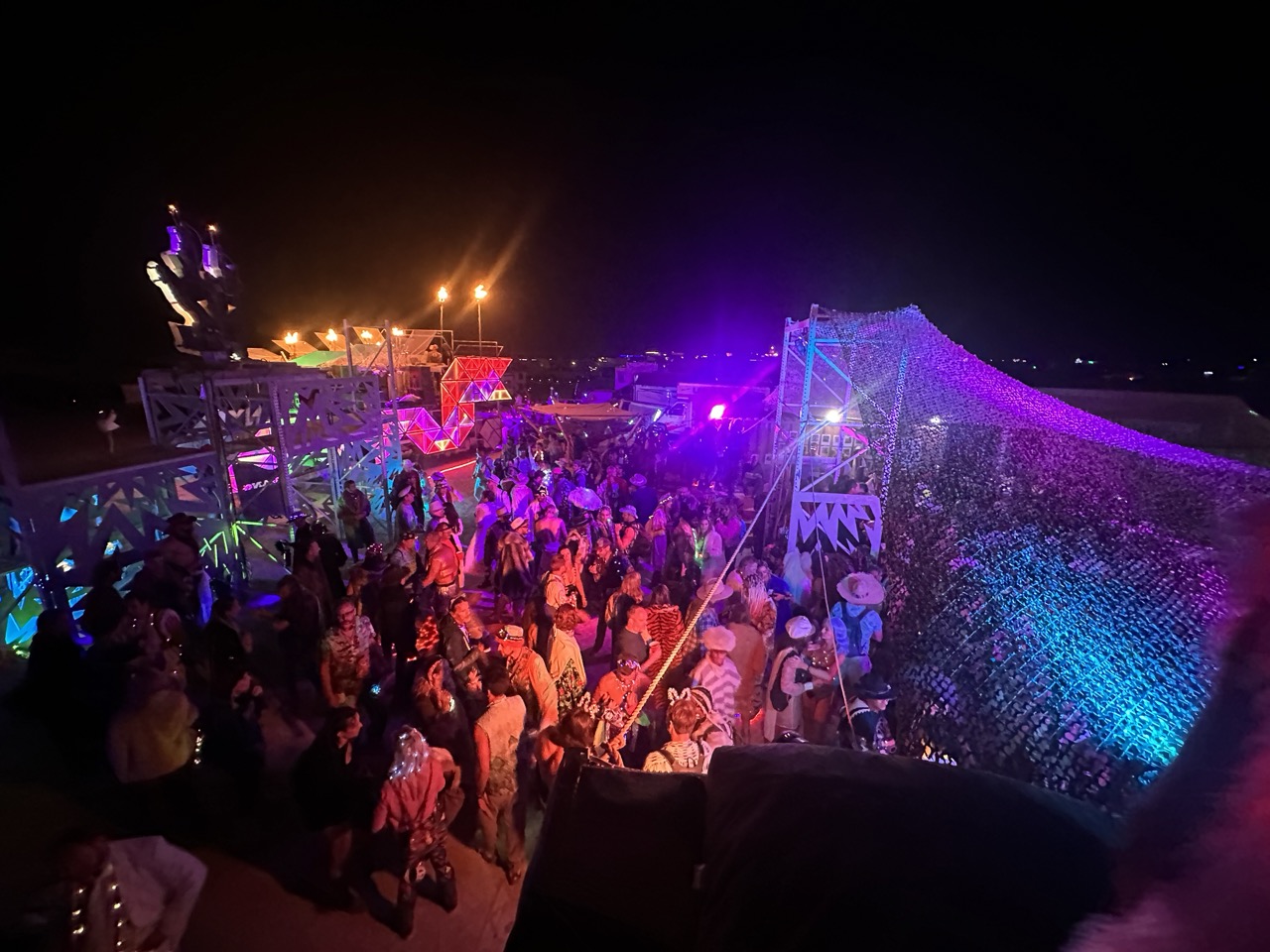 Wide night shot of a crowded Camp Bang Bang dance floor and lighting structures.